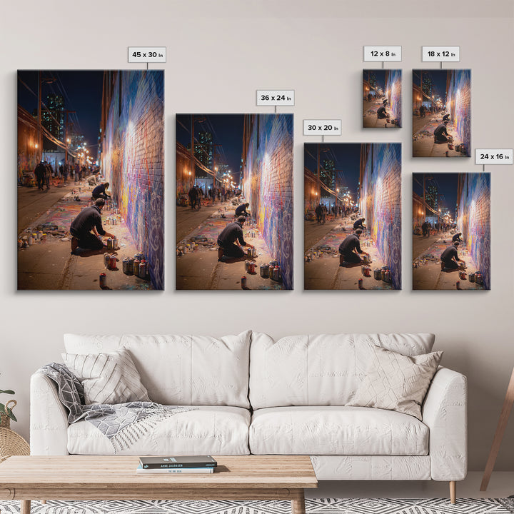 Nighttime Street Artist Painting Bright Graffiti Mural On City Wall - Colorful Wall Art Framed Canvas Print For Home