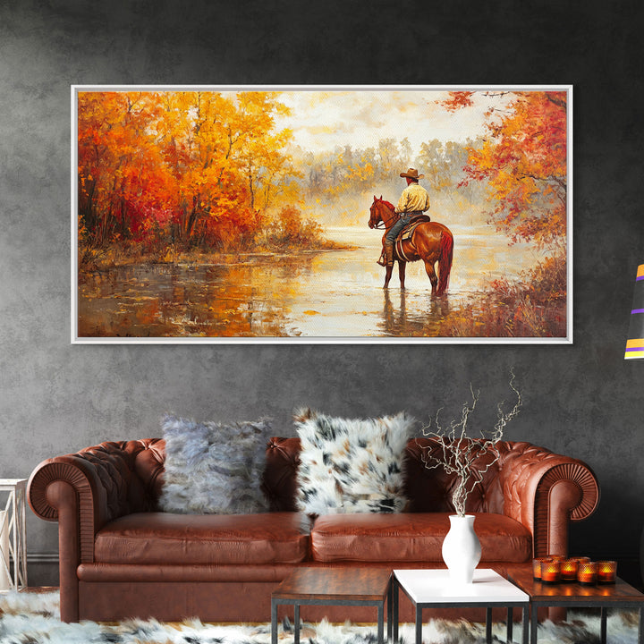 Cowboy sitting by campfire near a lake in the woods with autumn leaves, Framed Canvas Print, moody fall wall art, rustic western home decor